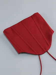 Detailed view of a stylish red corset waist belt with boning and adjustable ties.