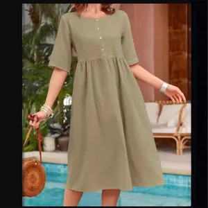 Women's loose casual cotton linen dress with round neck and button detail for summer