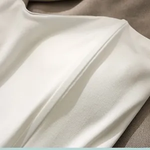 Detailed macro view showing structured boning and smooth fabric texture of white corset top