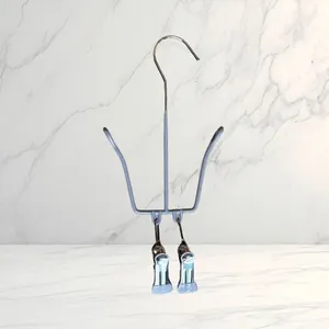 Detailed view of blue stainless steel shoe drying rack with dual clips and hooks