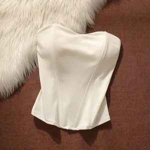 Detailed close-up view of a white fishbone corset tube top with smooth fabric texture