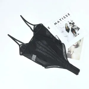 Macro view of black sheer mesh patchwork suspender bodysuit for women laid flat
