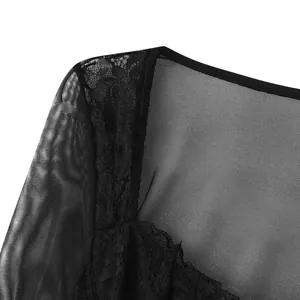 Close-up detail of black floral lace and mesh fabric on a square-neck long-sleeve top.