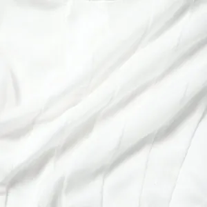 Close-up macro view of white semi-transparent mesh fabric texture and soft pleated folds.