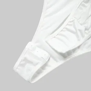 Macro detail view of white mesh bodysuit featuring adjustable snap-button crotch closure.