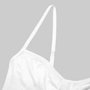 Detailed view of the adjustable shoulder strap and mesh fabric of a white bodysuit