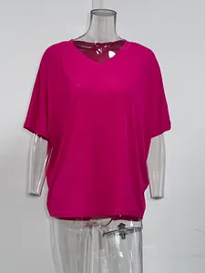 Close-up of bright pink V-neck ribbed T-shirt on transparent mannequin