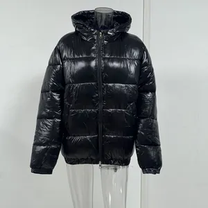 Detailed view of a glossy black winter hooded puffer jacket with warm lining