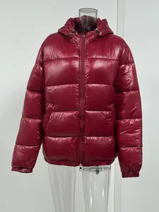 Detail view of the glossy red hooded puffer jacket featuring premium warm padding