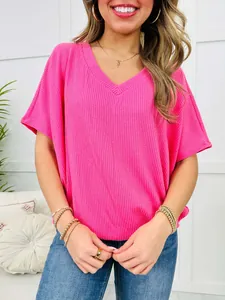 Close-up detail of bright pink V-neck ribbed knit short sleeve t-shirt for women