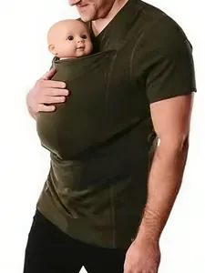 Close-up of a man wearing a green kangaroo carrier T-shirt with a baby doll inside