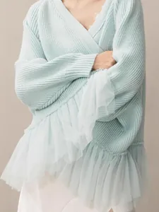 Light blue V-neck knit sweater with elegant white tulle ruffle hem and long sleeves.
