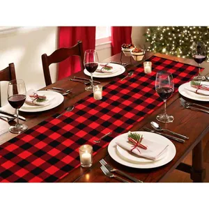 Classic red and black buffalo plaid Christmas table runner for festive holiday dining.