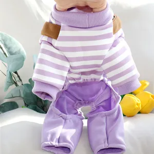 Close-up view of purple and white striped four-legged pet overalls with soft texture.