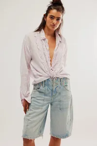 Detail view of ruffled lavender cotton linen long-sleeved shirt with V-neckline