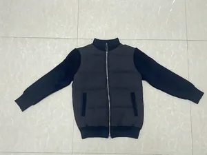 Navy blue men's bomber jacket with knit patchwork sleeves and a zip front closure.