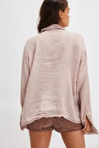 Back view of a mauve linen cotton shirt featuring delicate lace trim on the hem and cuffs.