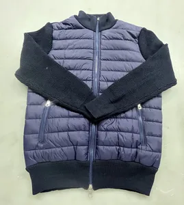 Navy blue padded bomber jacket with knitted sleeves and stand collar detail