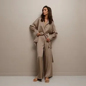 Elegant champagne silk-like pajama set for women featuring long sleeve shirt and wide pants.