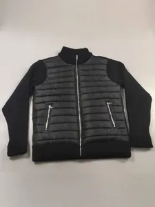 Detail view of men's knitted patchwork puffer jacket with stand collar and zippers