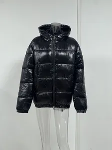 High-quality detail view of a glossy black hooded puffer jacket on a display mannequin.