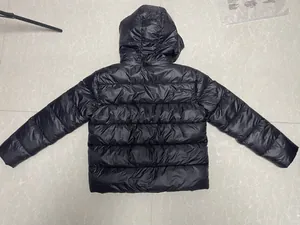 Detailed back view of a shiny black hooded puffer jacket for men with horizontal quilting.
