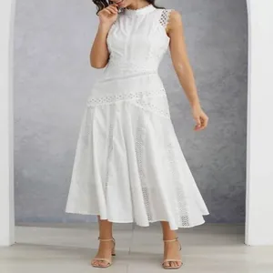 Detail view of white French sleeveless lace hollow design dress on model