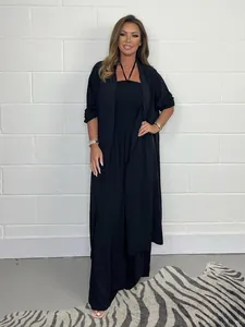 Full body model view of black two-piece jumpsuit and long cardigan set