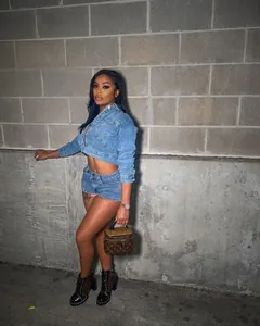 Detailed view of trendy women's light blue denim two-piece jacket and shorts outfit set