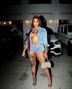 Two-piece denim set featuring a cropped jacket and tight shorts in urban street style outfit