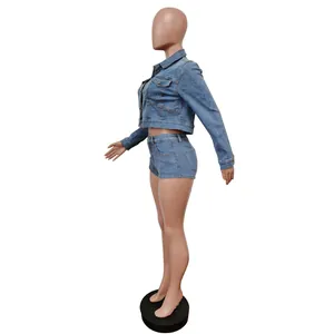 Side view detail of a stylish two-piece blue denim set with cropped jacket and shorts.