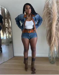 Full body view of a retro denim two-piece set featuring orange contrast stitching trim