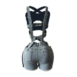 Back view detail of denim overall shorts with criss-cross straps and raw hem