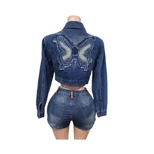 Detailed back view of a blue cropped denim jacket featuring a butterfly embroidery patch
