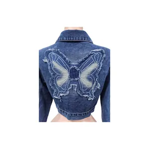 Detail view of a cropped denim jacket featuring a large butterfly embroidery on the back.