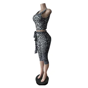 Side view of leopard print two-piece set including crop top and tie-waist pants