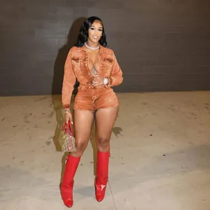 Model showcasing a vibrant orange long-sleeve stretchy denim romper jumpsuit shorts