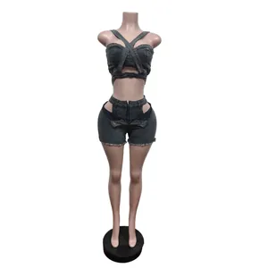 Detailed view of grey denim two-piece set with cross-over halter top and cutout shorts