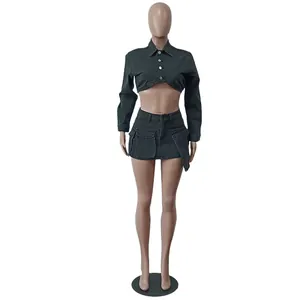 Detail of dark grey denim set featuring crop jacket and skirt with 3D pockets