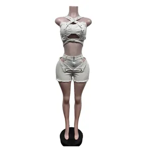 Beige denim two-piece set with crossover straps and cut-out shorts on mannequin