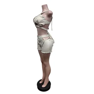 Side view of a stylish beige cut-out denim vest and matching shorts set on mannequin