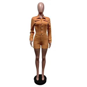 Long-sleeve stretch denim romper jumpsuit shorts in orange displayed on a mannequin