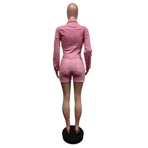Back view of a vibrant pink long-sleeved stretch denim jumpsuit shown on a mannequin.