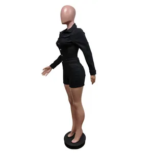Side view detail of a black long-sleeve stretch denim romper shown on a mannequin
