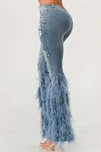 Close-up of high stretch denim jeans with pearl accents and fluffy feather trim.