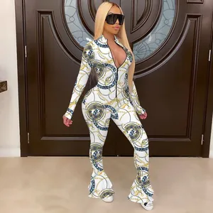 Detailed view of white jumpsuit with elegant gold chain print and flared fishtail legs.