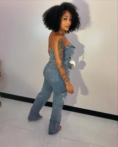 Full length side view of a stylish blue strapless denim cargo jumpsuit on a model