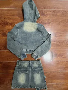 Back view of vintage washed hooded denim jacket and mini skirt set on rustic wooden floor