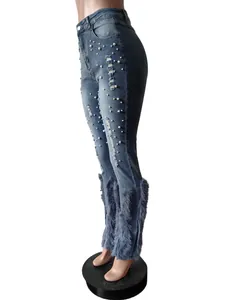 Side view of high-waisted distressed denim jeans with pearl beads and feather trim