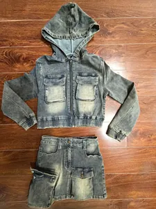 Detail view of a vintage wash denim set including a hooded jacket and skirt.